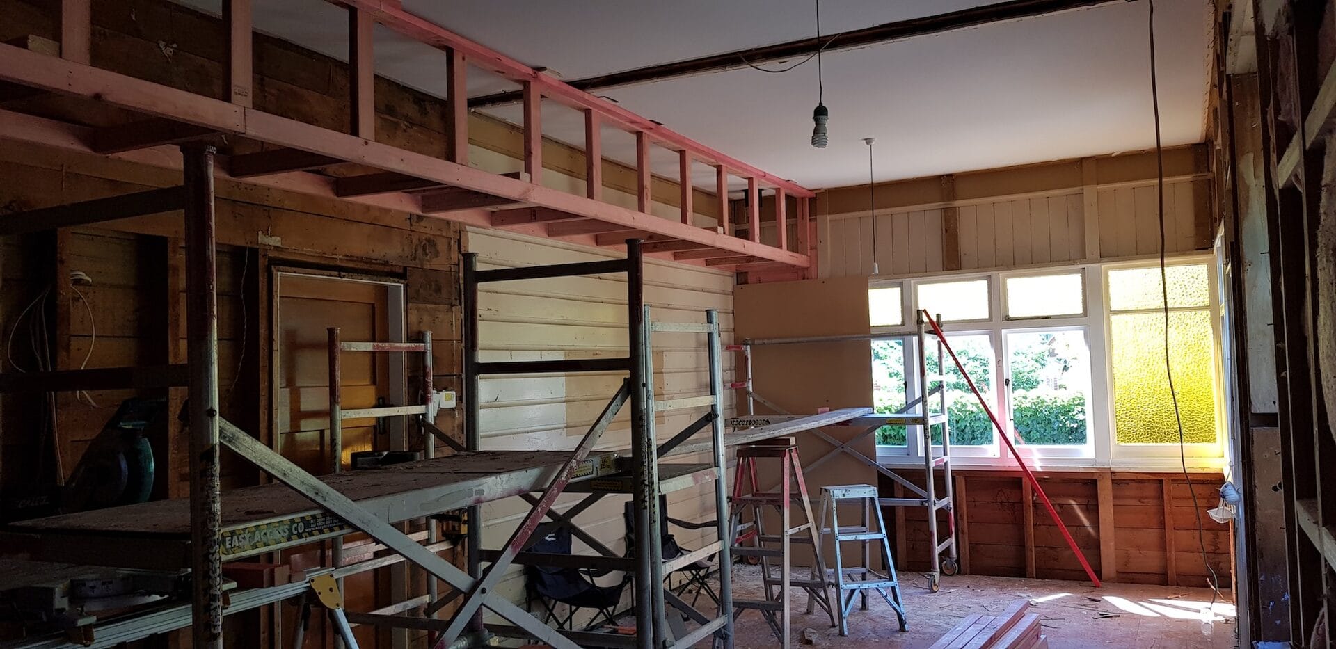Major Discovery Homes renovation in progress, showing structural work and original villa framing